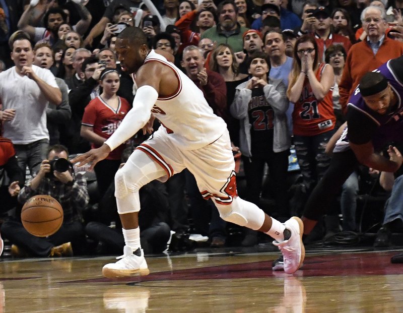 The Associated Press STILL NEEDING VOTES: Chicago Bulls guard Dwyane Wade (3) steals the ball against the Sacramento Kings during the second half of an NBA basketball game in Chicago, Saturday. Wade and Carmelo Anthony are both looking for votes to be selected as a reserve for the All-Star Game next month.