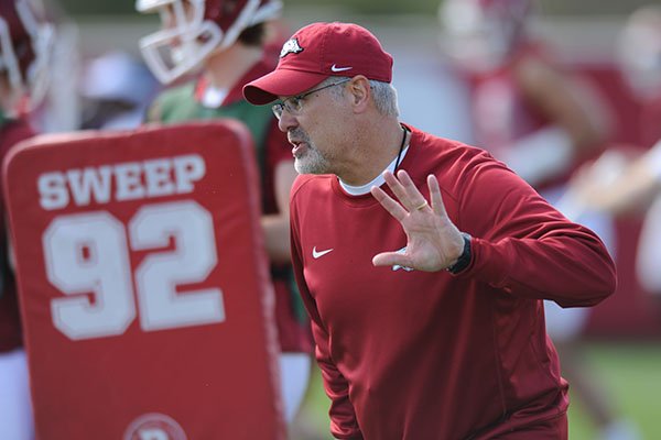 Arkansas assistant coach Paul Rhoads speaks with his players Thursday, March 31, 2016, during practice at the university's practice field on campus in Fayetteville.