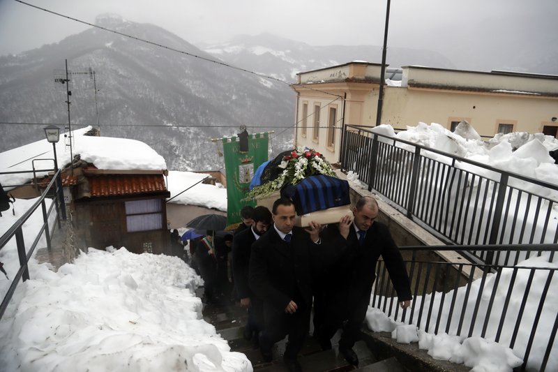 The coffin of Alessandro Giancaterino, one of the victims of the avalanche which buried the Hotel Rigopiano, is shoulder carried prior to the start of the funeral service in Farindola, central Italy,Tuesday, Jan. 24, 2017. The death toll from an avalanche in central Italy climbed to 14 on Tuesday as hopes began to fade that any of the 15 people still missing might be found alive under a mountain resort buried by tons of snow and rubble. (AP Photo/Gregorio Borgia)
