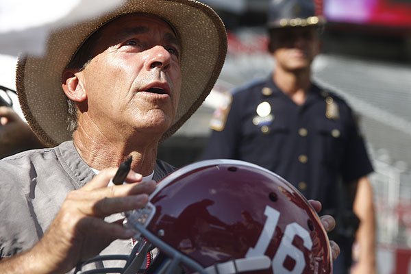 Alabama coach Nick Saban signs autographs during the college football fan day, Sunday, Aug. 7, 2016, at Bryant-Denny Stadium in Tuscaloosa, Ala. (AP Photo/Brynn Anderson)