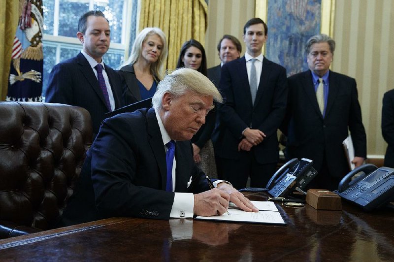 President Donald Trump signs an executive order Tuesday that “invites” energy company TransCanada to “re-submit its application” for the Keystone XL pipeline project. 