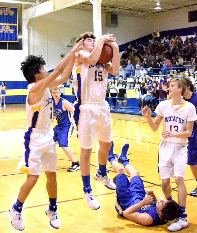 Photo by Mike Eckels Decatur&#8217;s Levi Newman (15) pulls down a rebound in the second quarter of the Decatur-St.Paul conference matchup at Peterson Gym in Decatur Jan. 20. The Bulldogs took the victory in the 2017 Colors Day game, 63-26.