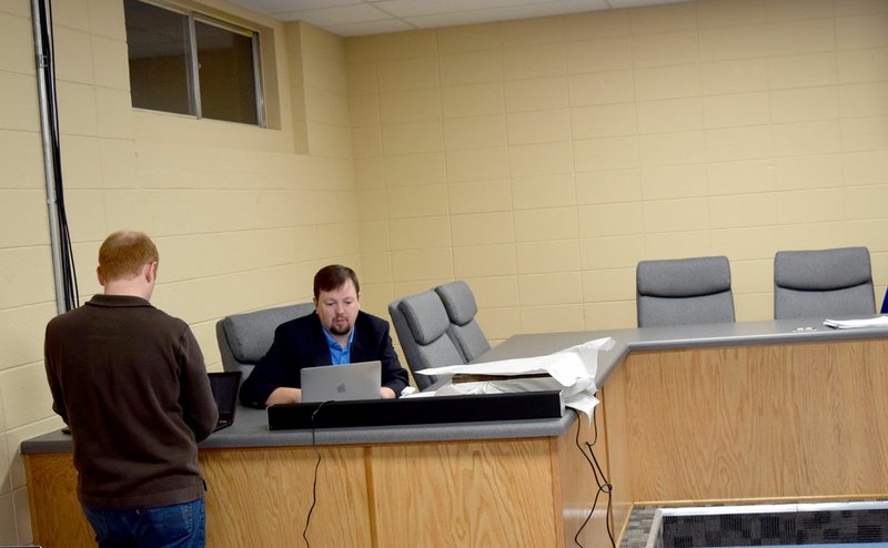 Photo by Mike Eckels Charles Weber (left) and Jeff Gravette put the finishing touches on the superintendent&#8217;s report prior to the first school board meeting in the Decatur Community Media Center at Decatur Middle School Jan. 16.