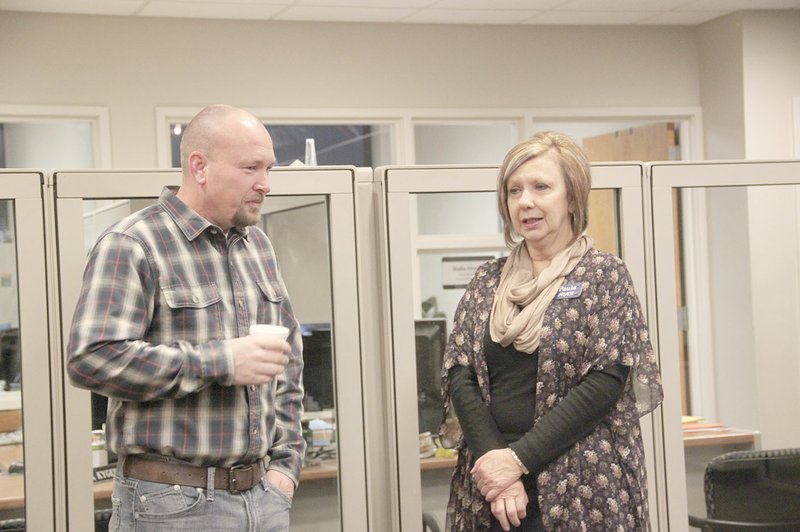 LYNN KUTTER ENTERPRISE-LEADER Keith Purifoy with Legend Realty in Farmington visits with Paula Ditmars of Arvest Bank at the Farmington Area Chamber of Commerce Coffee Chat on Friday morning.