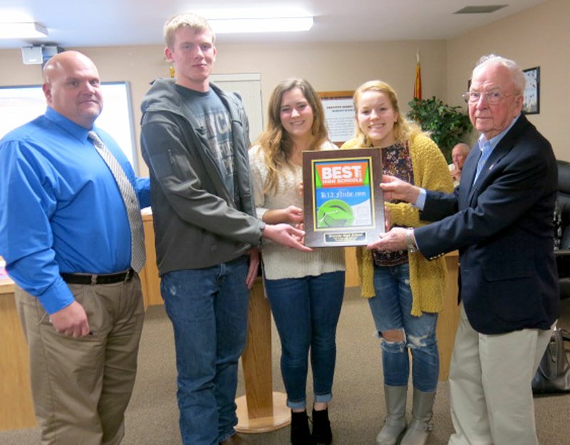 Photo by Susan Holland Jay Chalk (left), Gravette High School principal, posed with GHS Student Council officers at last Monday&#8217;s Gravette school board meeting as Drew Hendren, student council treasurer; Alex Krewson, secretary; and Robin Davis, president, accepted a plaque from school board vice-president John Edwards. The plaque, awarded by niche.com, recognized Gravette as being one of the &#8220;Best High Schools in Arkansas&#8221; for the third year in a row. Gravette High School was rated as 24th out of the 298 high schools in the state.