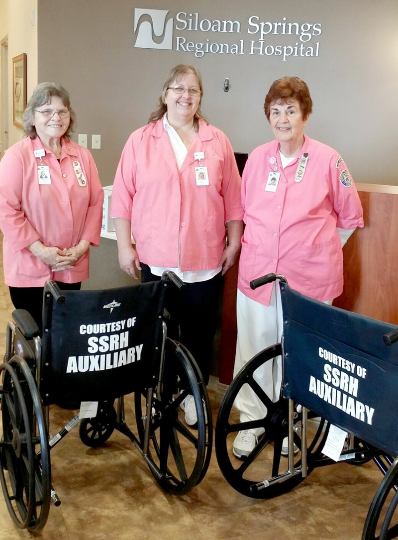 Submitted Photo Siloam Springs Hospital Auxiliary recently donated two new wheelchairs to Siloam Springs Regional Hospital for patients to use while visiting the hospital. Auxilians Barbara Harless (left), Kathy Ferguson and Nancy Van Poucke were on hand to see the new wheelchairs as they arrived in the SSRH Lobby.