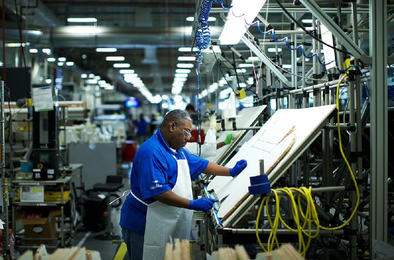 A Boeing employee works last month at the company’s factory in North Charleston, S.C. The world’s largest plane-maker on Wednesday reported fourth-quarter revenue of $23.3 billion. 