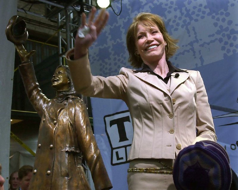 Mary Tyler Moore holds a tam and waves to the crowd after the unveiling of a bronze statue capturing her flinging her tam in Minneapolis, Wednesday, May 8, 2002. A crowd of about 2,000 gathered for the unveiling at the intersection in downtown Minneapolis where Moore originally twirled her hat in the opening sequence of her 1970's television hit, "The Mary Tyler Moore Show." 