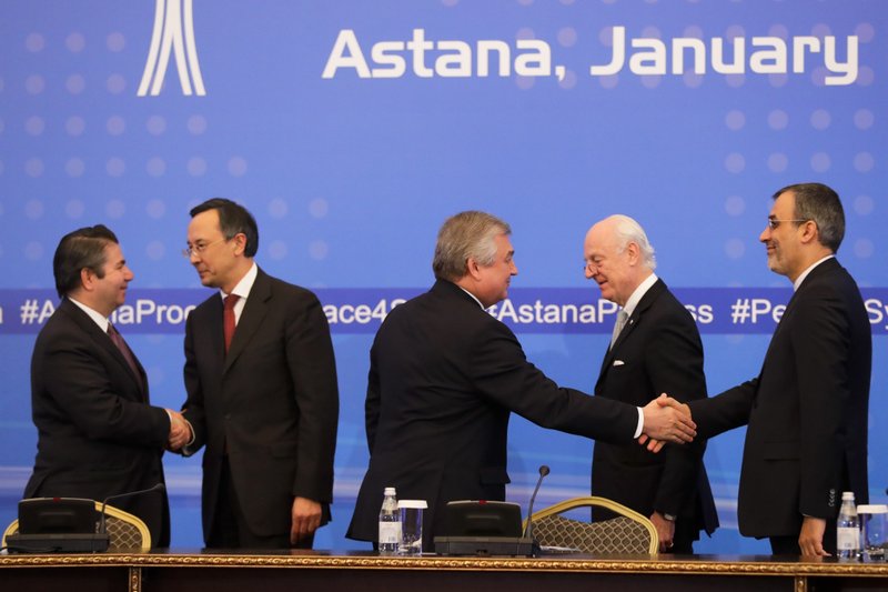 Turkish Foreign Ministry Deputy Undersecretary Sedat Onal, left, and Kazakh Foreign Minister Kairat Abdrakhmanov shake hands, as Russia's special envoy on Syria Alexander Lavrentiev and Iran's Deputy Foreign Minister Hossein Jaber Ansari, right, shake hands and UN Syria envoy Staffan de Mistura stand after the final statement following the talks on Syrian peace in Astana, Kazakhstan, Tuesday, Jan. 24, 2017.
