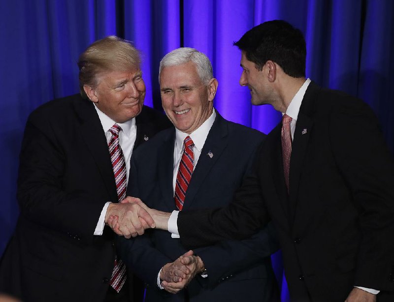 President Donald Trump, accompanied by Vice President Mike Pence, greets House Speaker Paul Ryan before speaking to GOP lawmakers at a policy retreat Thursday in Philadelphia.