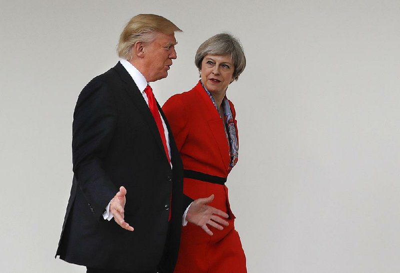 President Donald Trump and British Prime Minister Theresa May stroll together Friday at the White House. During the visit, Trump reaffirmed the two countries’ “special relationship.” 