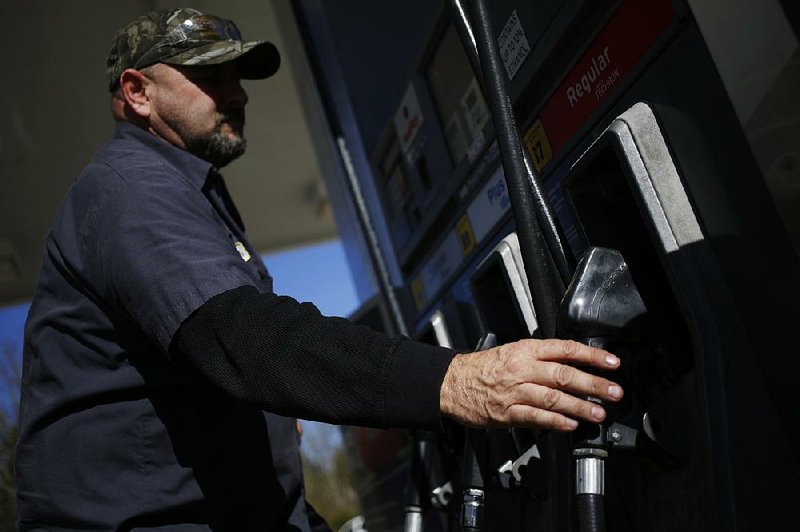 A motorist stops earlier this week at a Chevron gas station in Guild, Tenn., near Chattanooga. Chevron on Friday posted a $497 million loss for 2016.