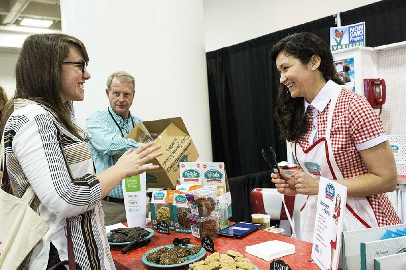 Regina Organo, a former molecular biologist, speaks with a visitor to her No-Bake Cookie Co. booth at the Winter Fancy Food Show in San Francisco, earlier this month. 