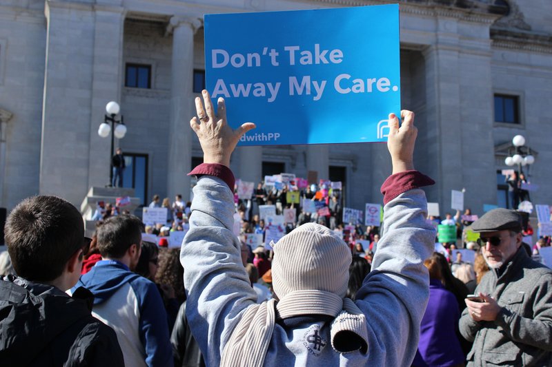 A rally attendee holds a sign in support of Planned Parenthood at the 7th Annual Rally for Reproductive Justice in Little Rock on Jan. 28.