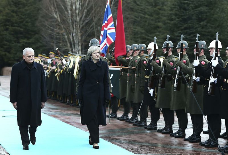 Turkish Prime Minister Binali Yildirim and British counterpart Theresa May review an honor guard Saturday during a ceremony welcoming May on her visit to Ankara, Turkey.