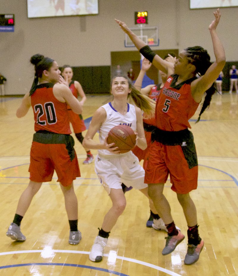 Photo courtesy of JBU Sports Information John Brown junior Kimmy Deines weaves her way through Bacone defenders during the first half of Thursday&#8217;s game at Bill George Arena. The Golden Eagles defeated Bacone 79-52. JBU returned to action at Mid-America Christian on Saturday. Results were not available at presstime.