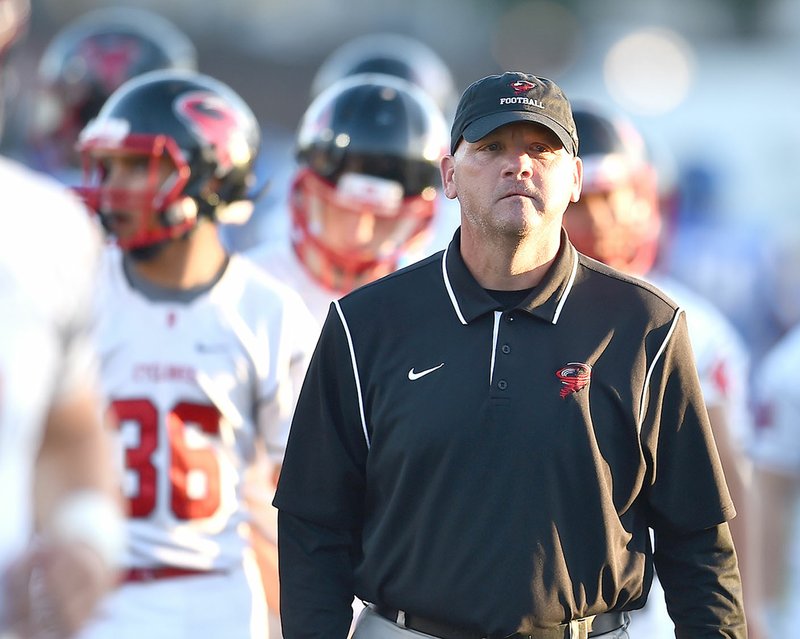 Billy Dawson watches his players warm up Sept. 30 before playing Sheridan at Yellowjacket stadium in Sheridan. Dawson led Russellville to the Class 6A championship. He recently was hired as the head coach of the Fayetteville program, which has hoisted the 7A state title in back-to-back years.