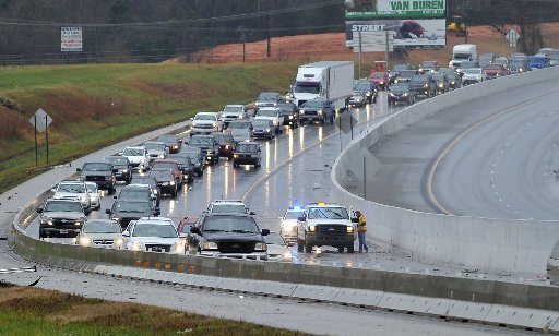 Traffic backs up in the Northbound lane of Interstate 49 south of the Lowell exit December 26, 2015 as highway department workers fix a drainage issue. Saturday storms brought standing water to many local roads.
