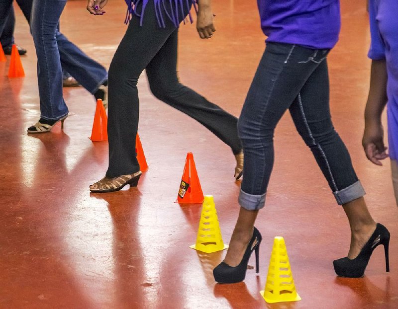 Students dance through a line of agility cones during a recent Chicago steppin’ class at It’s Your Move Fitness Studio in Little Rock. Steppin’, a partners’ dance that has long been popular in the black community up north, has made its way to central Arkansas as an alternative to line dances.