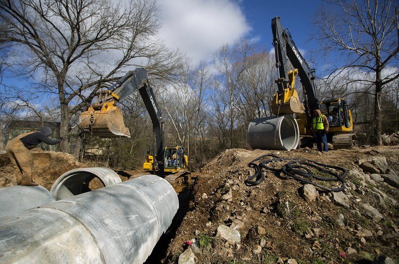 NWA Democrat-Gazette/JASON IVESTER A Benton County Road Department crew install culverts Thursday on Ashley Lane in Pea Ridge. Benton County expects to have about $750,000 in state aid money to spend on county road projects this year.