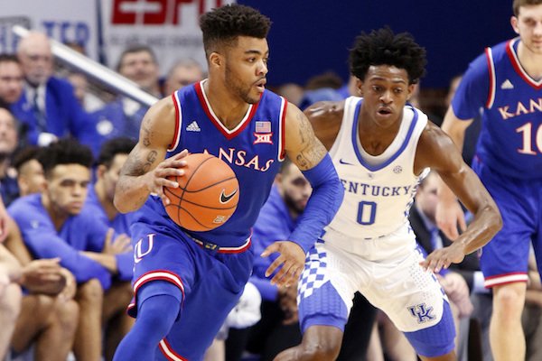 Kansas' Frank Mason III, left, looks for an opening on Kentucky's De'Aaron Fox (0) during the first half of an NCAA college basketball game, Saturday, Jan. 28, 2017, in Lexington, Ky. (AP Photo/James Crisp)