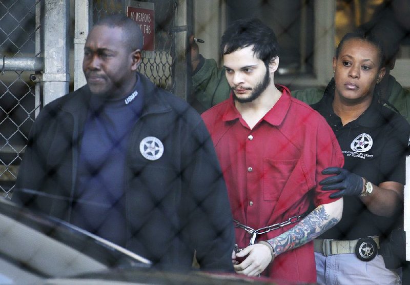 Esteban Santiago, who faces charges in a mass shooting at a Florida airport, leaves the Broward County jail in Fort Lauderdale for an arraignment hearing Monday in federal court.