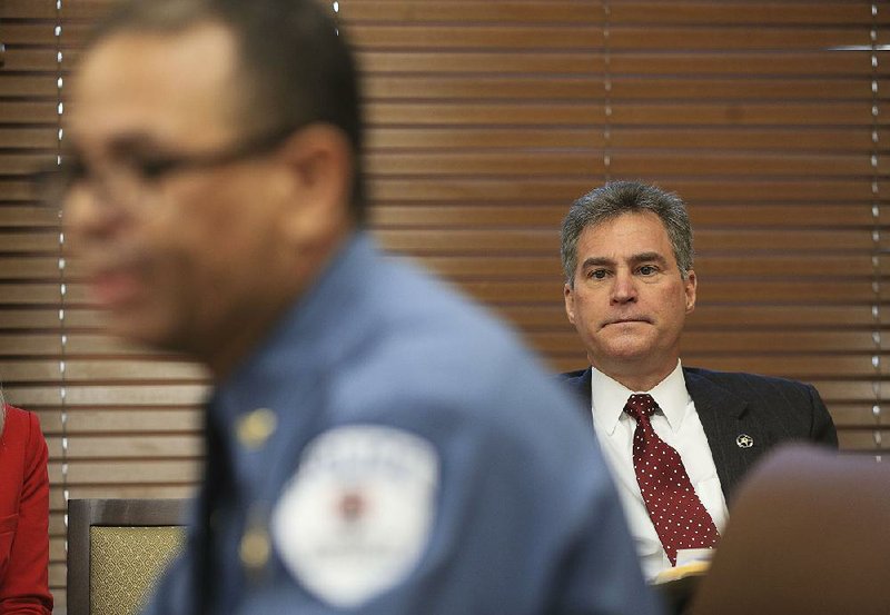 Rep. Charlie Collins listens Tuesday as University of Arkansas at Fayetteville Police Director Steve Gahagans speaks against Collins’ bill to allow college faculty members to carry concealed handguns. “When you bring more guns to the table you have to understand you bring more risk,” Gahagans said.