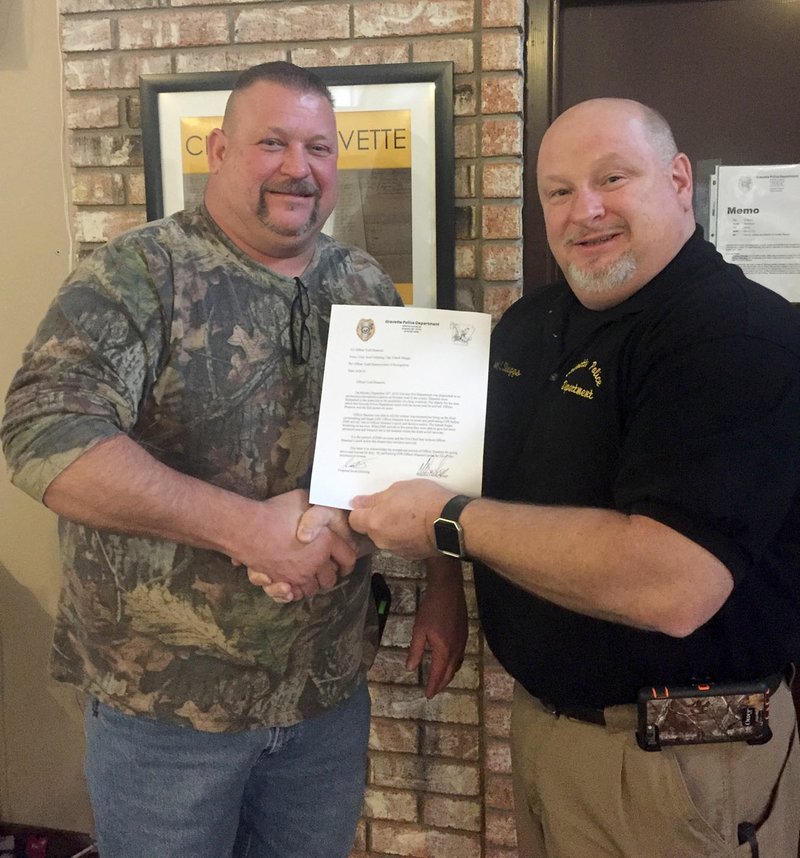 Photo by Penny Berry Officer Todd Shannon (left), of the Gravette Police Department, was awarded a letter of commendation for his efforts in resuscitating an unresponsive woman in September, 2016. Shannon, who was first on the scene and started CPR on the woman, was credited with saving her life.