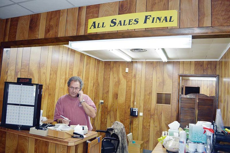 Steve Dayer talks on the phone one day this week in the nearly empty Dayer Jewelers, which closed after 61 years in business in downtown Conway. Dayer said several factors played into the decision, including family illness and internet sales. Also closing last month was Kordsmeier Furniture, which had been in downtown Conway since 1949.