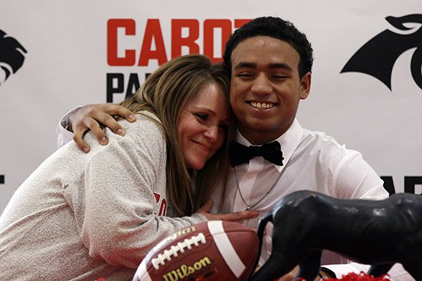 Jarrod Barnes, right, hugs his mother Gretchen after signing a national letter of intent to play at the University of Arkansas during a ceremony Wednesday, Feb. 1, 2017, at Cabot High School. 