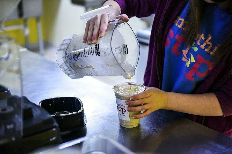 Elizabeth Long, a Smoothie Stop employee, pours a smoothie at the YMCA in Charleston, W.Va., last month. Businesses added 246,000 jobs in January, according to an ADP survey.