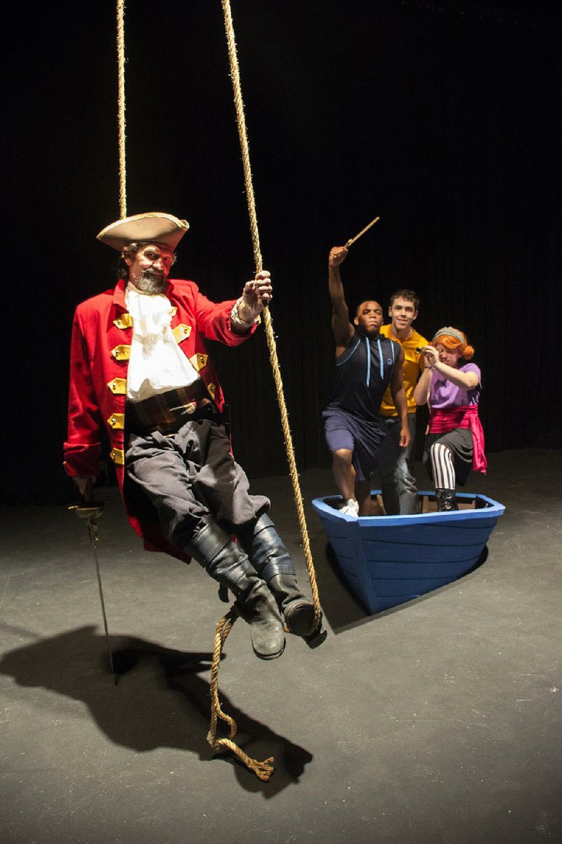 Mark Hansen plays a ghostly pirate academy headmaster helping teach young pirate-wannabes (from left) Yusuf Richardson, Max Green and Joanna Huff in The Laughable Legend of Fancybeard the Bully Pirate at the Arkansas Arts Center Children’s Theatre.

