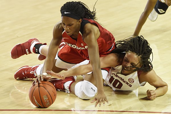 Arkansas forward Kiara Williams (10) and Georgia's Pachis Roberts (11) fight for a loose ball Thursday, Feb. 2, 2017, during their game at Bud Walton Arena in Fayetteville.
