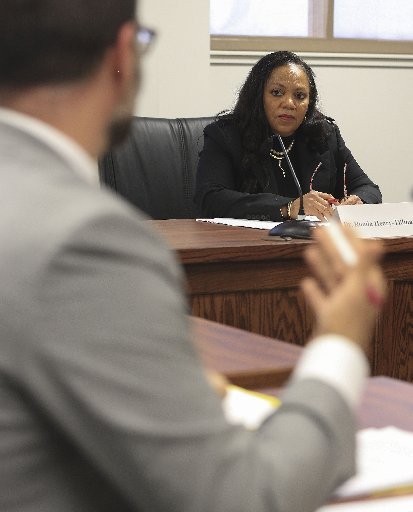 Newly elected Arkansas Medical Marijuana Commission Chairman Dr. Ronda Henry-Tillman (right) listens to a presentation on December 12, 2016, during the commission's first meeting from Department of Finance and Administration attorney Joel DiPippa.