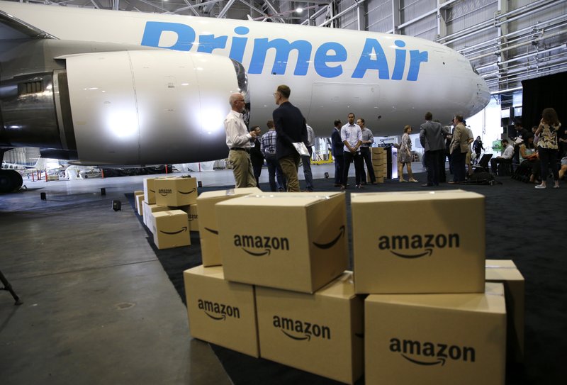 In this Thursday, Aug. 4, 2016, file photo, Amazon.com boxes are shown stacked near a Boeing 767 Amazon "Prime Air" cargo plane on display in a Boeing hangar in Seattle. 