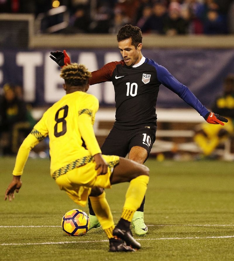 United States’ midfielder Benny Feilhaber (10) sends the ball past Jamaica’s Oniel Fisher to American teammate Jordan Morris for a goal in the 59th minute in a 1-0 U.S. victory.