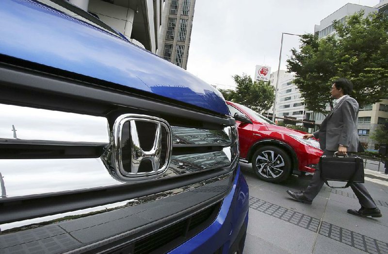 Vehicles are displayed outside Honda Motor Corp.’s headquarters in Tokyo. Honda sold a record number of vehicles in the U.S. and China last year. 
