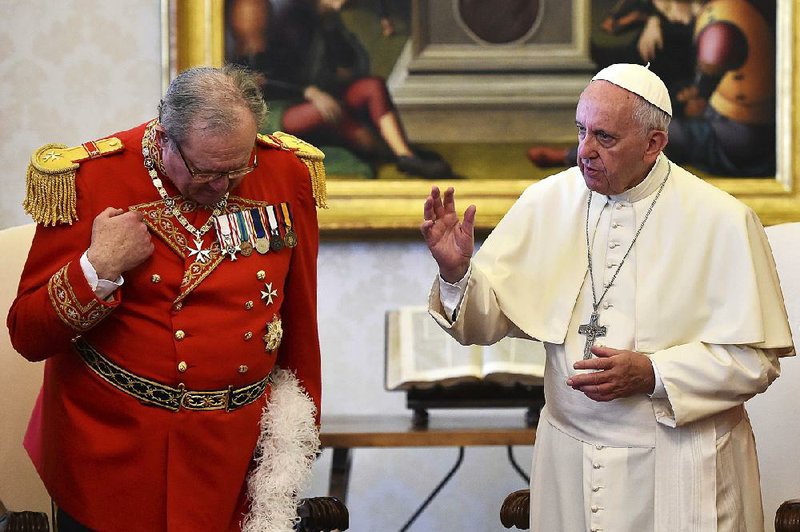 Pope Francis delivers a blessing during a June meeting with then-Grand Master of the Knights of Malta Matthew Festing. 