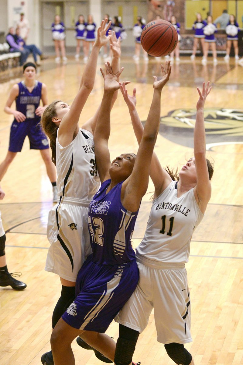 NWA Democrat-Gazette/BEN GOFF @NWABENGOFF Emma Palasak (left) and Lauren Hargus of Bentonville High jump for a rebound against Jasmine Franklin of Fayetteville on Friday at Bentonville's Tiger Arena.