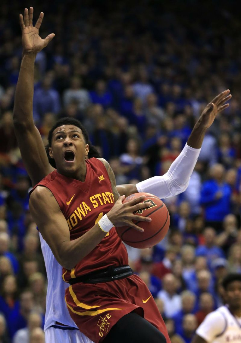 Iowa State guard Donovan Jackson (4) puts up a shot in front of Kansas guard Josh Jackson on Saturday during the Cyclones’ 92-89 overtime victory over the No. 3 Jayhawks at Allen Fieldhouse in Lawrence, Kan.