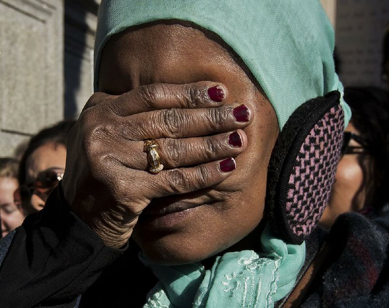 Nuar Adem, who is from Eritrea, listens to a speech Saturday at a rally near the White House protesting President Donald Trump’s immigration policies. 