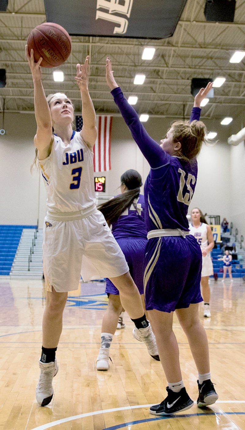 Photo courtesy of JBU Sports Information John Brown University junior Jana Schammel goes up for a basket Thursday in the Golden Eagles&#8217; win against Southwestern Assemblies of God (Texas). JBU played against Wayland Baptist (Texas) on Saturday. Results were not available at presstime.