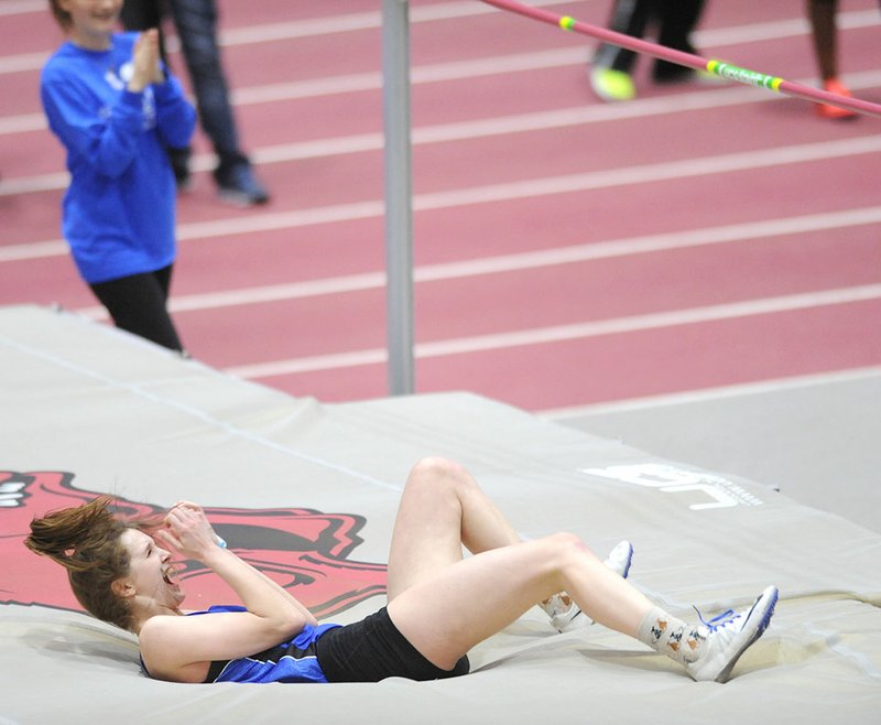 Hannah Martin of Rogers High celebrates her high jump of 5 feet, 7 inches, which set a state record, Saturday at the Randal Tyson Track Center in Fayetteville. Visit nwadg.com/photos for more pictures from the meet.