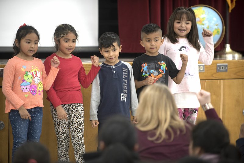 Kindergartners in Walker Elementary School’s English Language Development program recite The Three Little Pigs on Monday at the Springdale school. Results of a proficiency exam for students learning English show new strategies schools are implementing are having an impact with 22 students graduating out of the program at the school Tuesday compared to less than 10 last year.