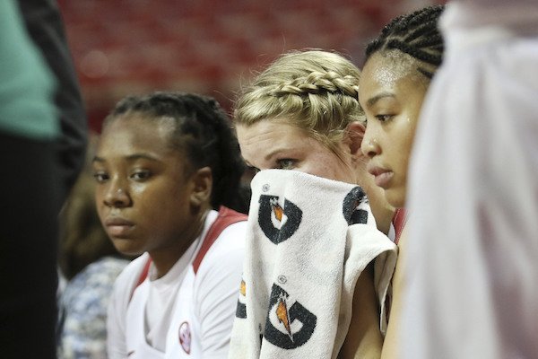 Arkansas' Keiryn Swenson, center, wipes sweat her face during a timeout in the first half of an NCAA college basketball game against South Carolina, Sunday, Feb. 5, 2017, in Fayetteville, Ark. (AP Photo/Samantha Baker)
