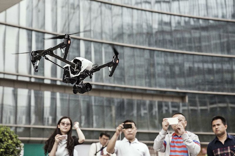 A drone demonstration last year at SZ DJI Technology Co. in Shenzhen, China, draws the attention of passers-by.