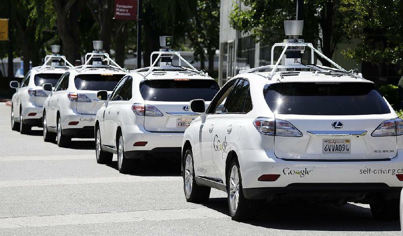A queue of Google self-driving Lexuses are seen outside an event at the Computer History Museum in Mountain View, Calif. in 2014.