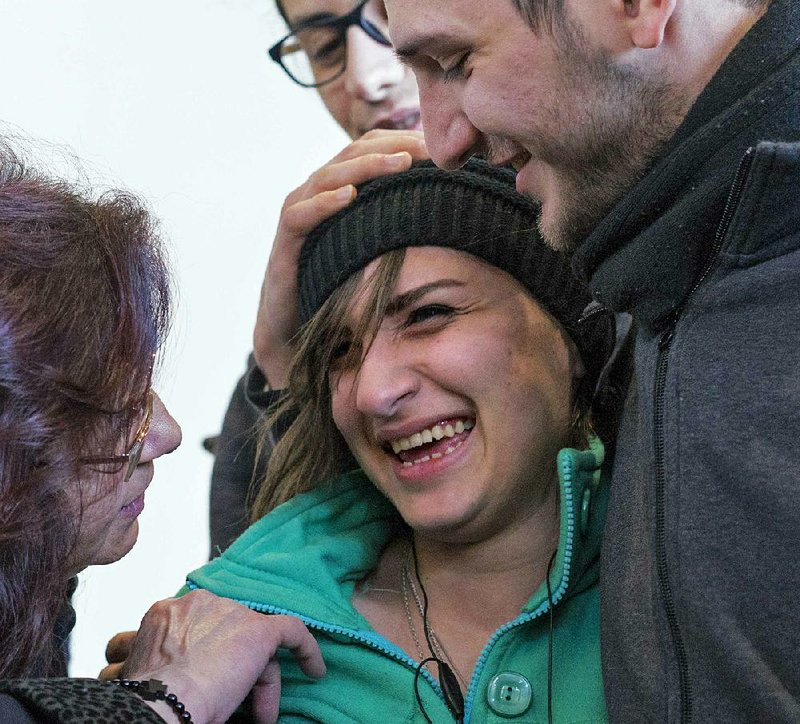 Tawfik Assali, 21, of Allentown, Pa., embraces his sister Sarah Assali, 19, on Monday at John F. Kennedy International Airport in New York after Sarah Assali and other family members arrived from Syria. The family reached the U.S. after previously being denied entry under President Donald Trump’s travel ban.
