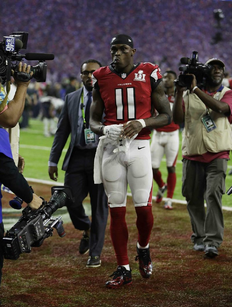 Atlanta wide receiver Julio Jones walks off the field after the team blew a 25-point second half lead in losing to New England on Sunday. Several questions might surround the Falcons in the offseason, including who they’ll hire as their new offensive coordinator.