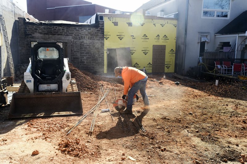 Daniel Campbell with Compass Construction out of Prairie Grove works Friday February 3, 2017 in the back of the new Taco Bell Cantina/Pickleman's sandwich shop area that use to be the old Common Grounds space in Fayetteville.